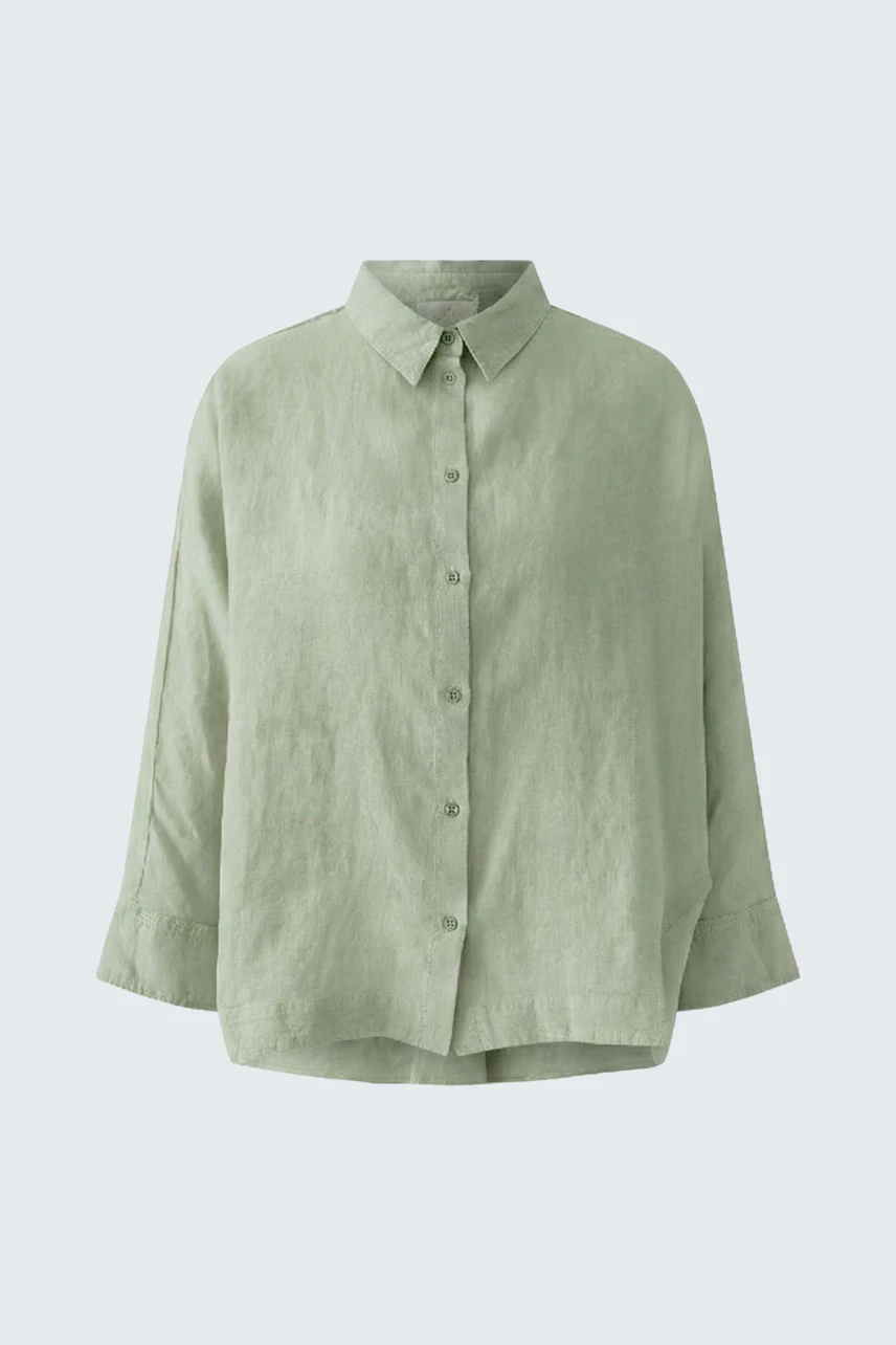 Casual women's blouse: Light green, loose-fit blouse with button-up front and classic collar.