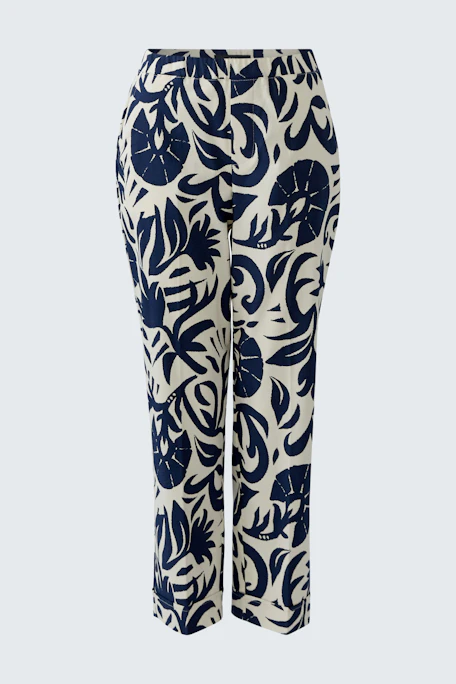 Casual women's pants: White pants with bold navy leaf print, perfect for a relaxed, stylish look.