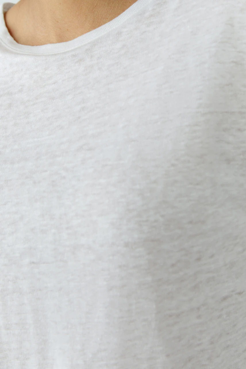 Casual white T-shirt: Close-up of fabric texture, showcasing simplicity and comfort.