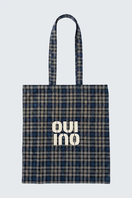 Plaid tote bag with "Oui" logo in white. Perfect for casual outings and daily use.