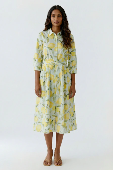Vibrant midi dress with lemon print, featuring long sleeves and a button-up front. Perfect for sunny days.