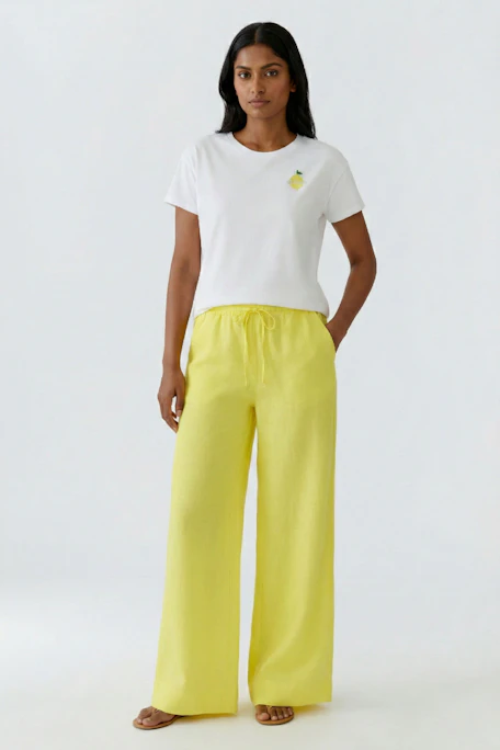 White T-shirt with lemon print on chest, short sleeves, and round neck. Casual and fresh look.