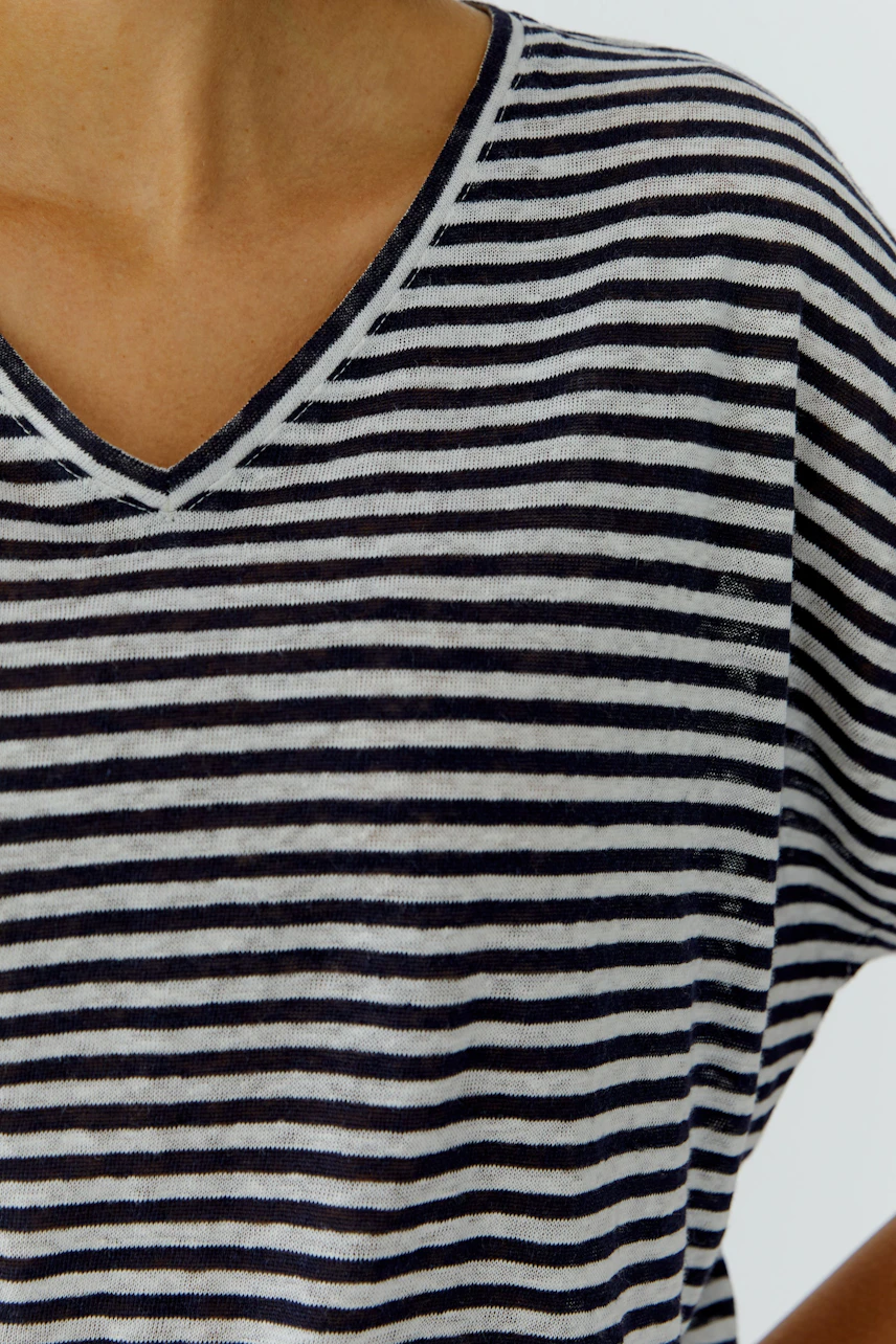 Striped T-shirt: Woman in a casual black and white striped T-shirt with a V-neck.