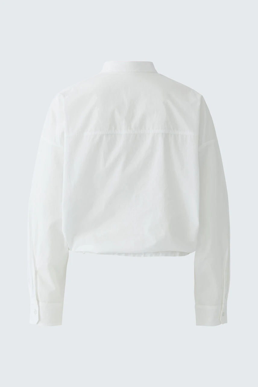 White women's shirt blouse: Simple, classic design with long sleeves and a straight cut.