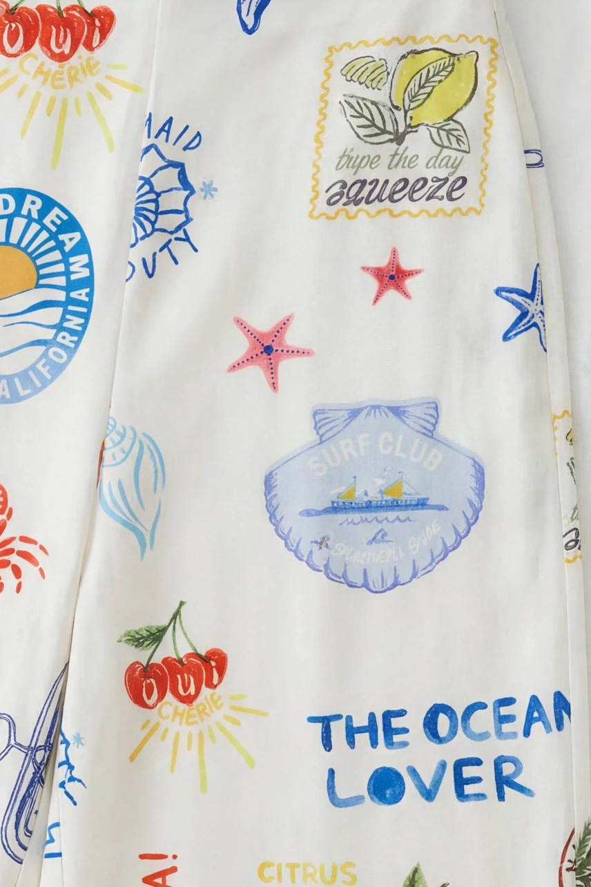 Colorful Marlene pants with playful beach-themed prints, perfect for a vibrant summer look.
