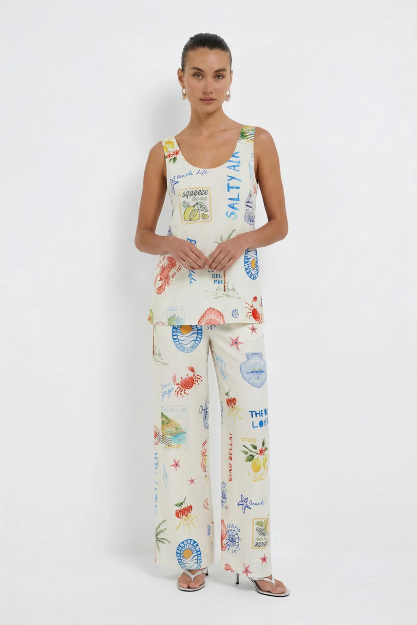 Casual Marlene pants: Woman in colorful print Marlene pants and matching top, standing confidently.