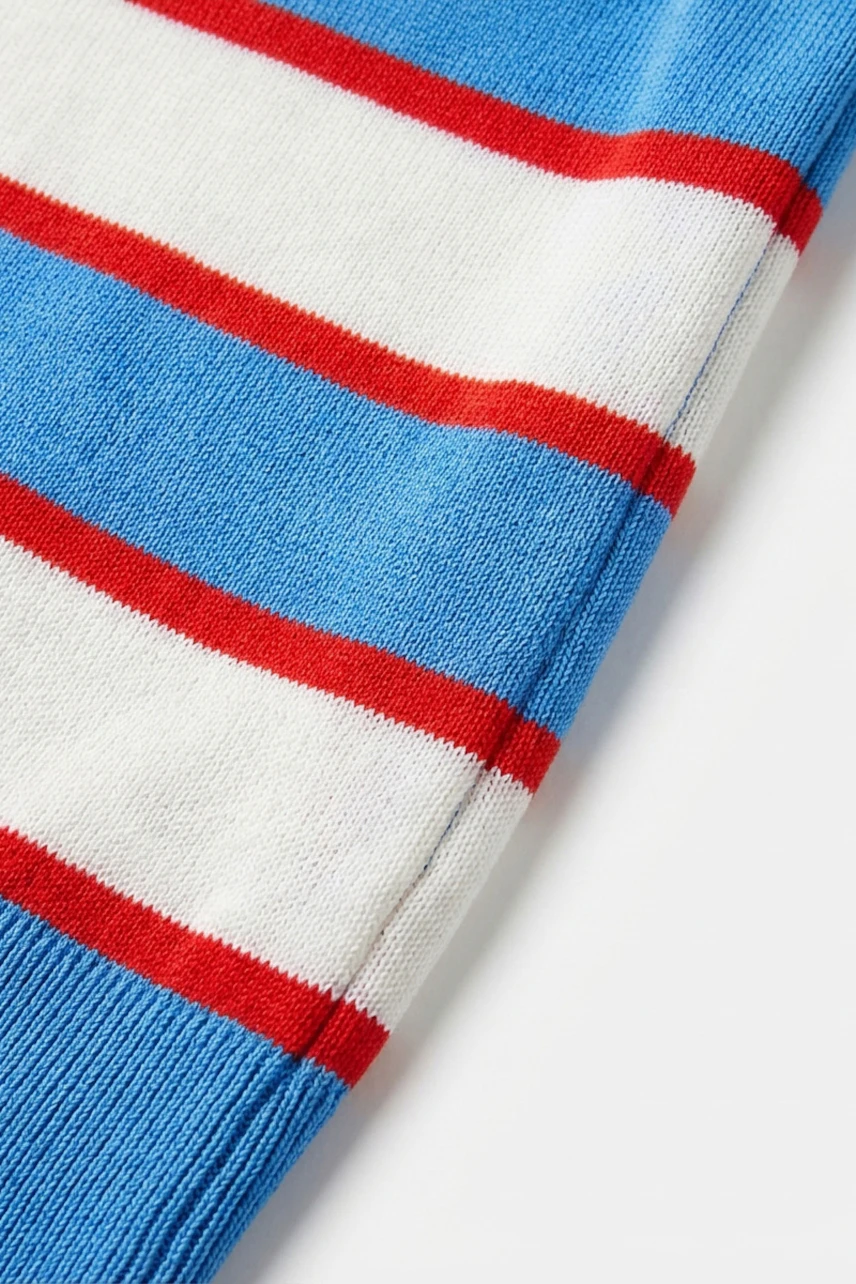 Colorful striped pullover: Blue, white, and red stripes on a soft fabric, perfect for casual wear.