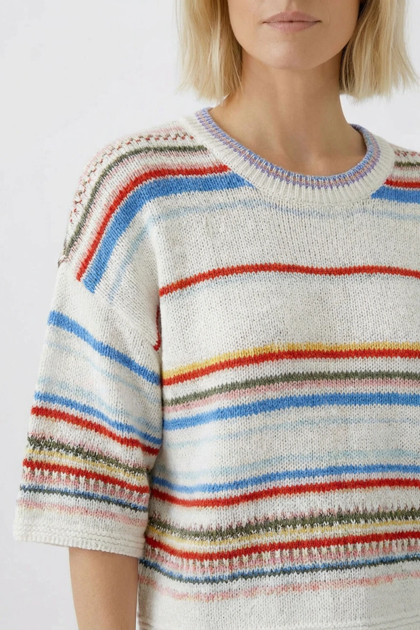 Casual women's pullover: Woman in a colorful striped pullover with short sleeves and a relaxed fit.