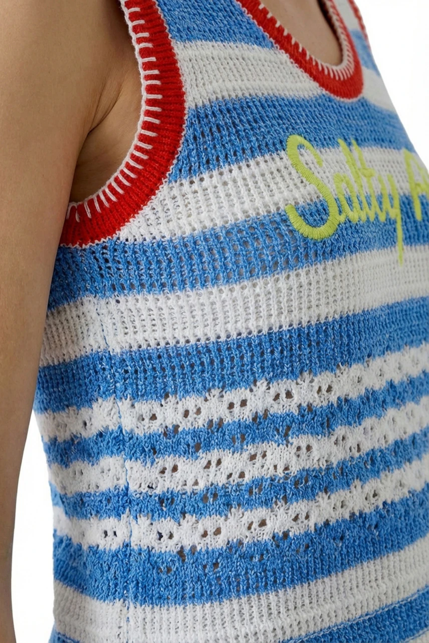 Striped knit top: Woman in blue and white striped top with red trim and yellow text detail.