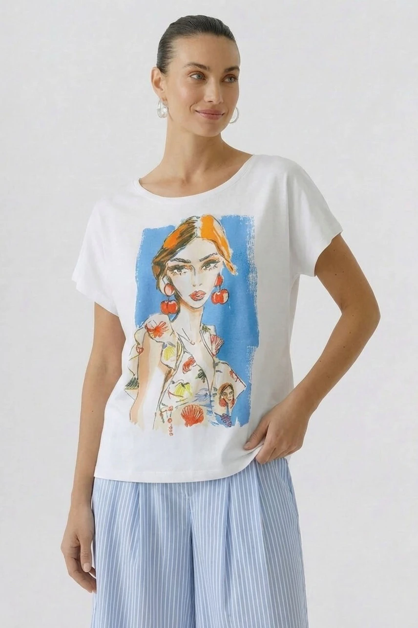 Casual T-shirt: Woman in a white T-shirt with colorful graphic print, paired with light blue striped pants.