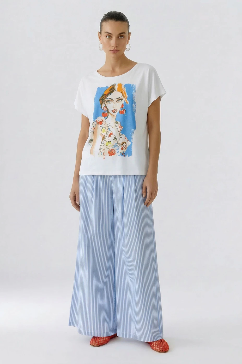 White T-shirt with colorful woman illustration, floral details, and short sleeves.