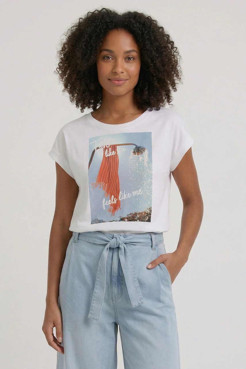 Casual T-shirt: Woman in a white T-shirt with graphic print, paired with light blue high-waisted pants.