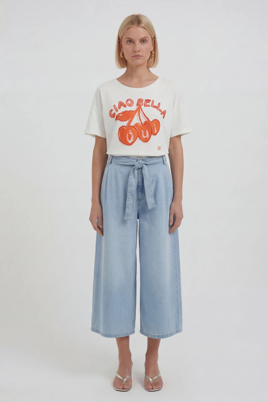 Casual T-shirt: Woman in white T-shirt with red print, paired with light blue wide-leg jeans.