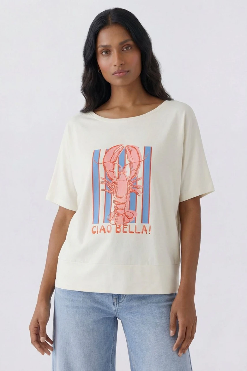 Casual women's T-shirt: Woman in a white T-shirt with a lobster print and 'Ciao Bella!' text, paired with jeans.