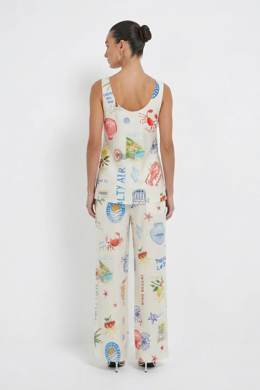 Casual women's top: Woman in a sleeveless, printed top with matching wide-leg pants, viewed from the back.