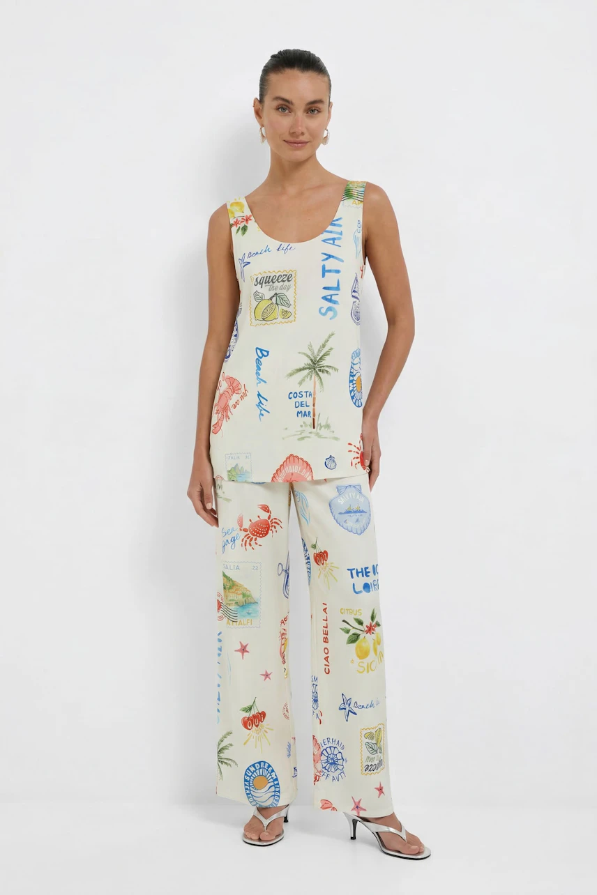 Casual women's top: Woman in a printed sleeveless top with beach motifs, paired with matching wide-leg pants.