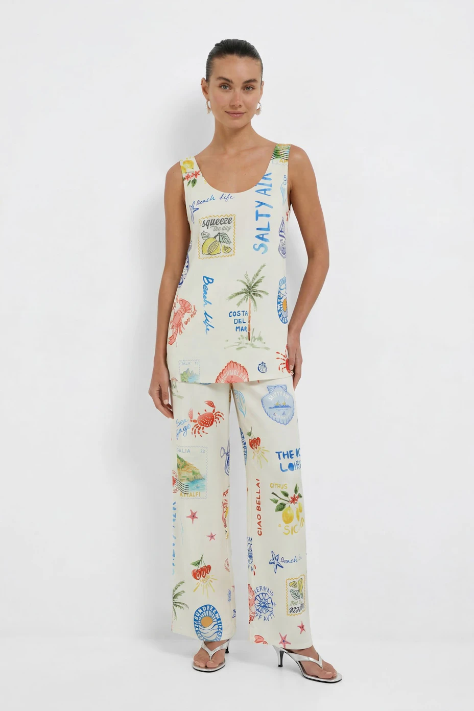 Colorful women's top with beach-themed prints, perfect for casual summer days.