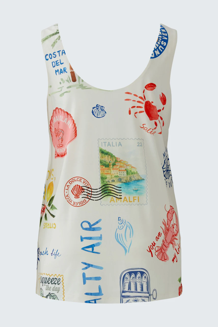 Colorful women's top with travel-themed prints, featuring stamps and seaside motifs on a white background.