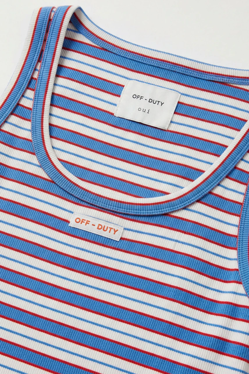 Striped tank top: Blue and red stripes on white fabric, casual and versatile for everyday wear.