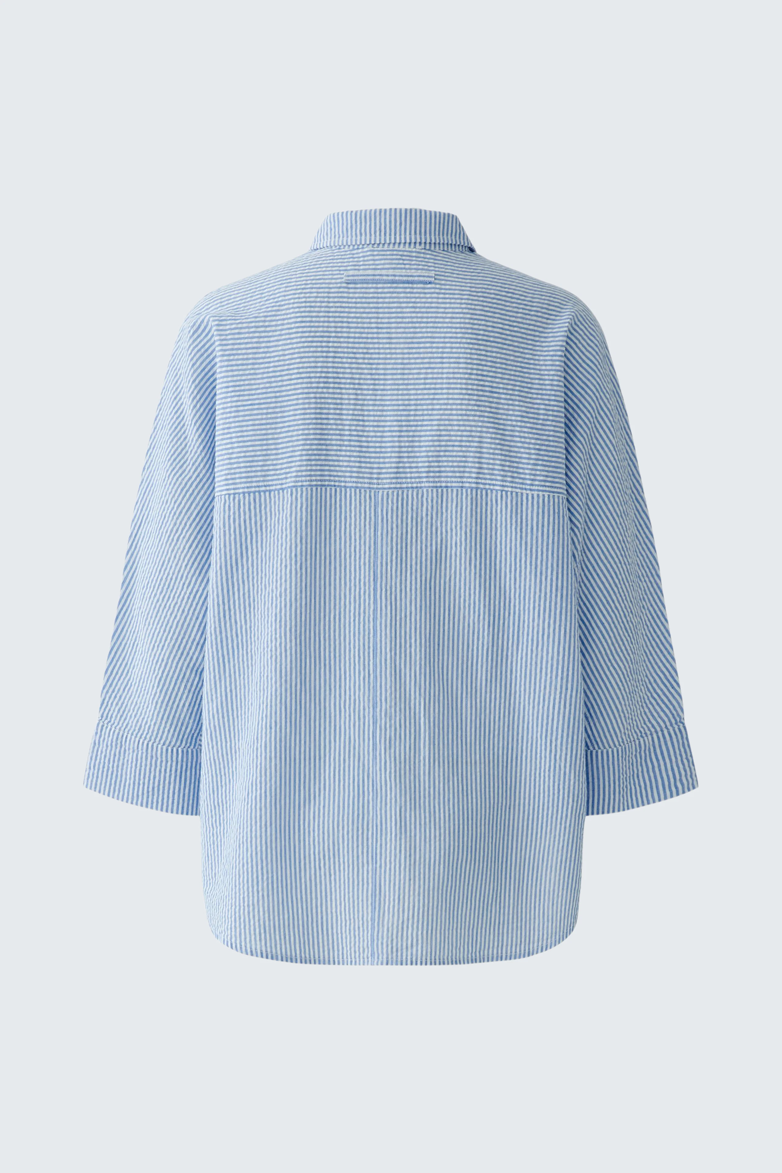Casual women's blouse: Light blue, loose-fit blouse with subtle stripes, perfect for everyday wear.