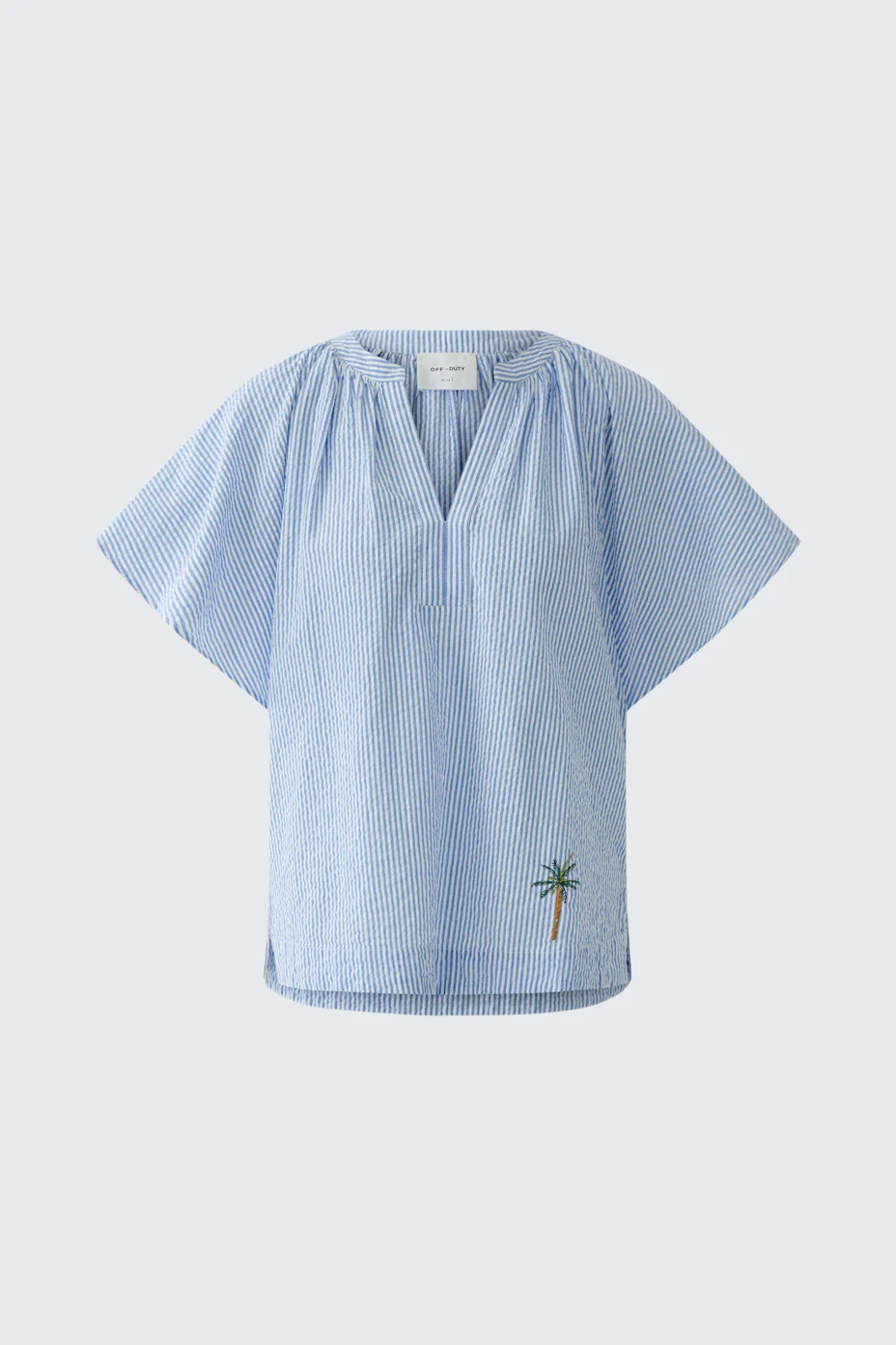 Casual women's blouse: Light blue blouse with short sleeves and palm tree embroidery.