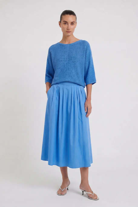 Vibrant blue midi skirt with a flowy silhouette, perfect for casual outings and versatile styling.