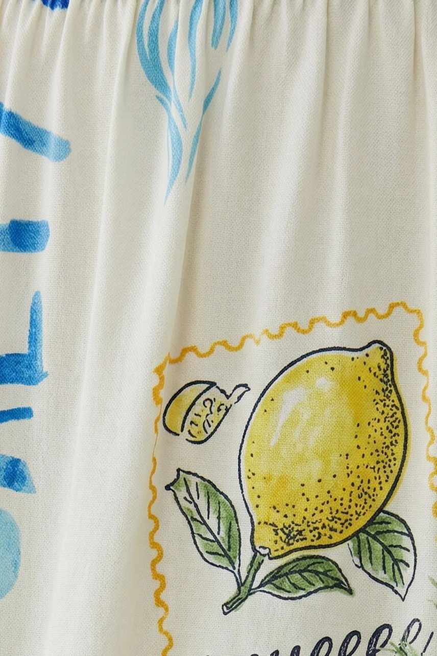 Maxi skirt with lemon print on white fabric, vibrant and fresh design for a lively look.