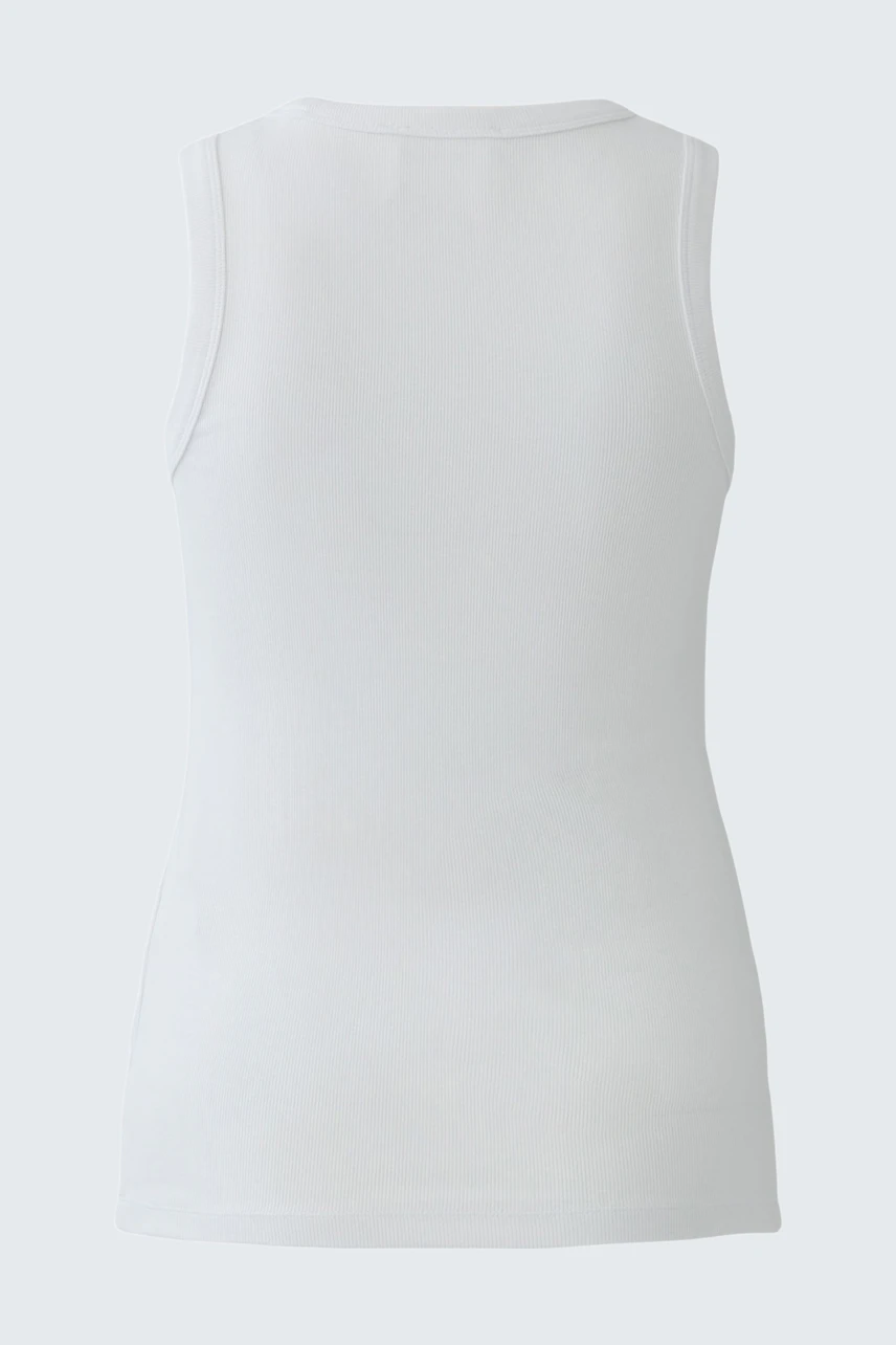 White tank top: Simple and versatile, perfect for layering or wearing alone.