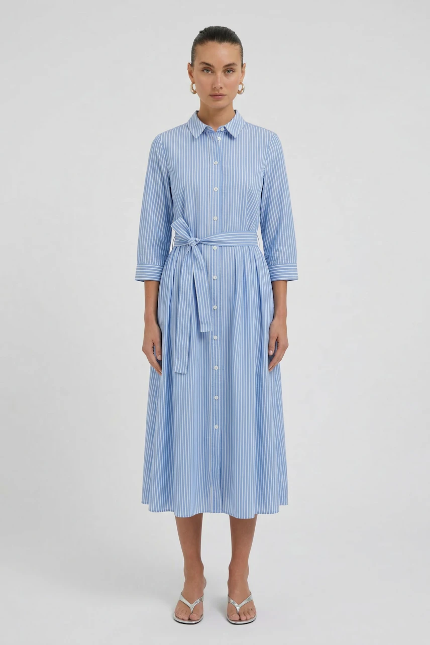Striped midi dress: Woman in a blue and white button-up dress with a waist tie, standing confidently.