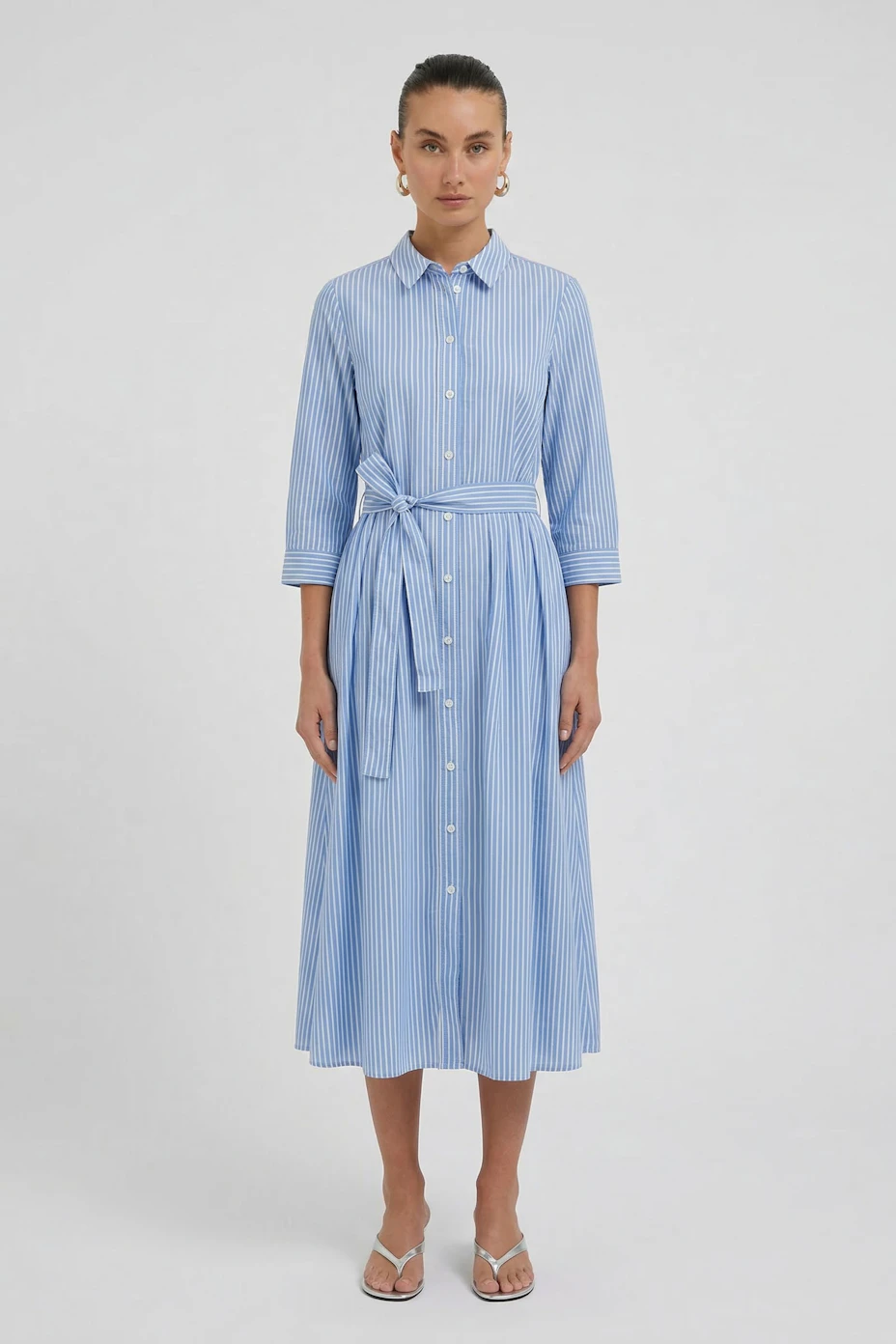 Striped blue midi dress with a belt, button-down front, and 3/4 sleeves. Casual and versatile.