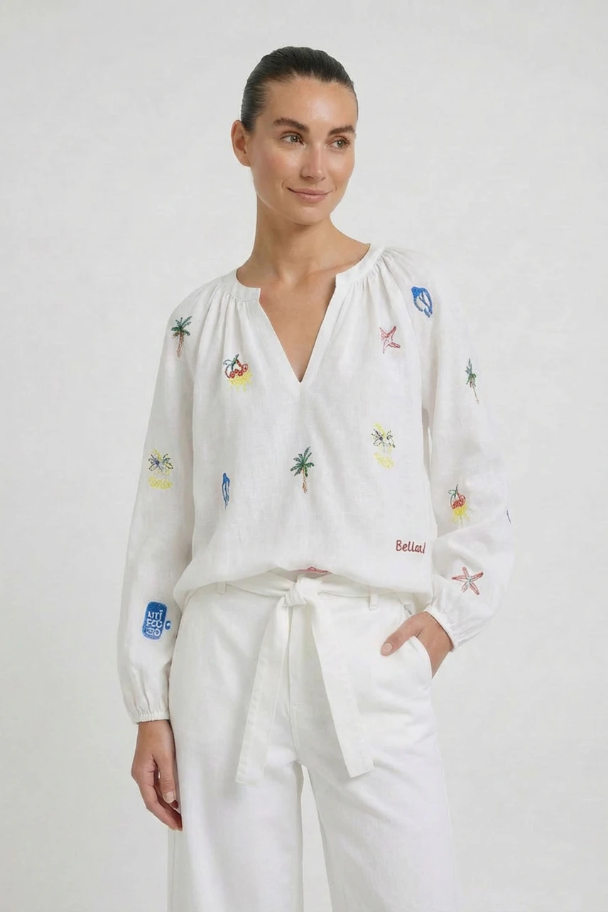 Casual tunic: Woman in a white tunic with colorful embroidery, paired with matching white pants.
