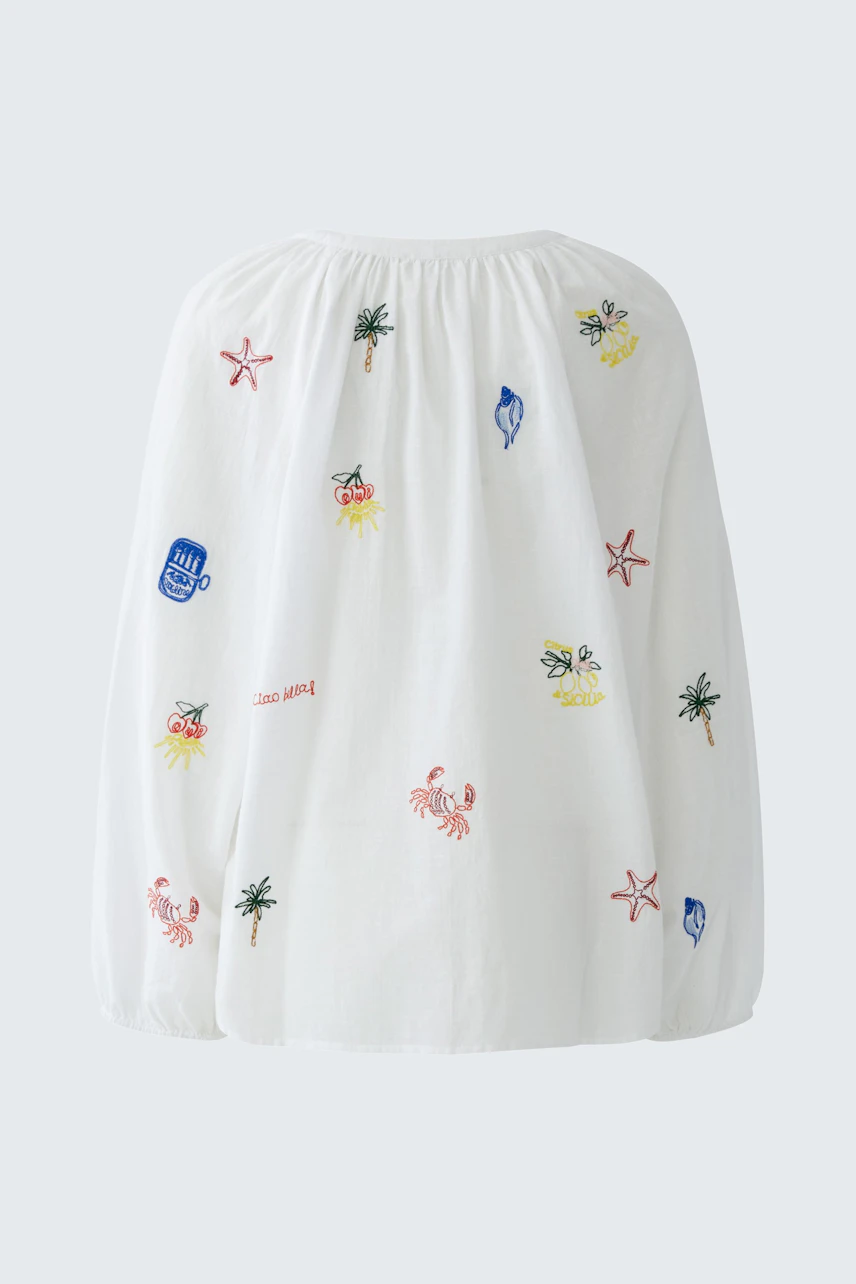 White tunic with colorful beach-themed embroidery, featuring crabs, palm trees, and starfish.