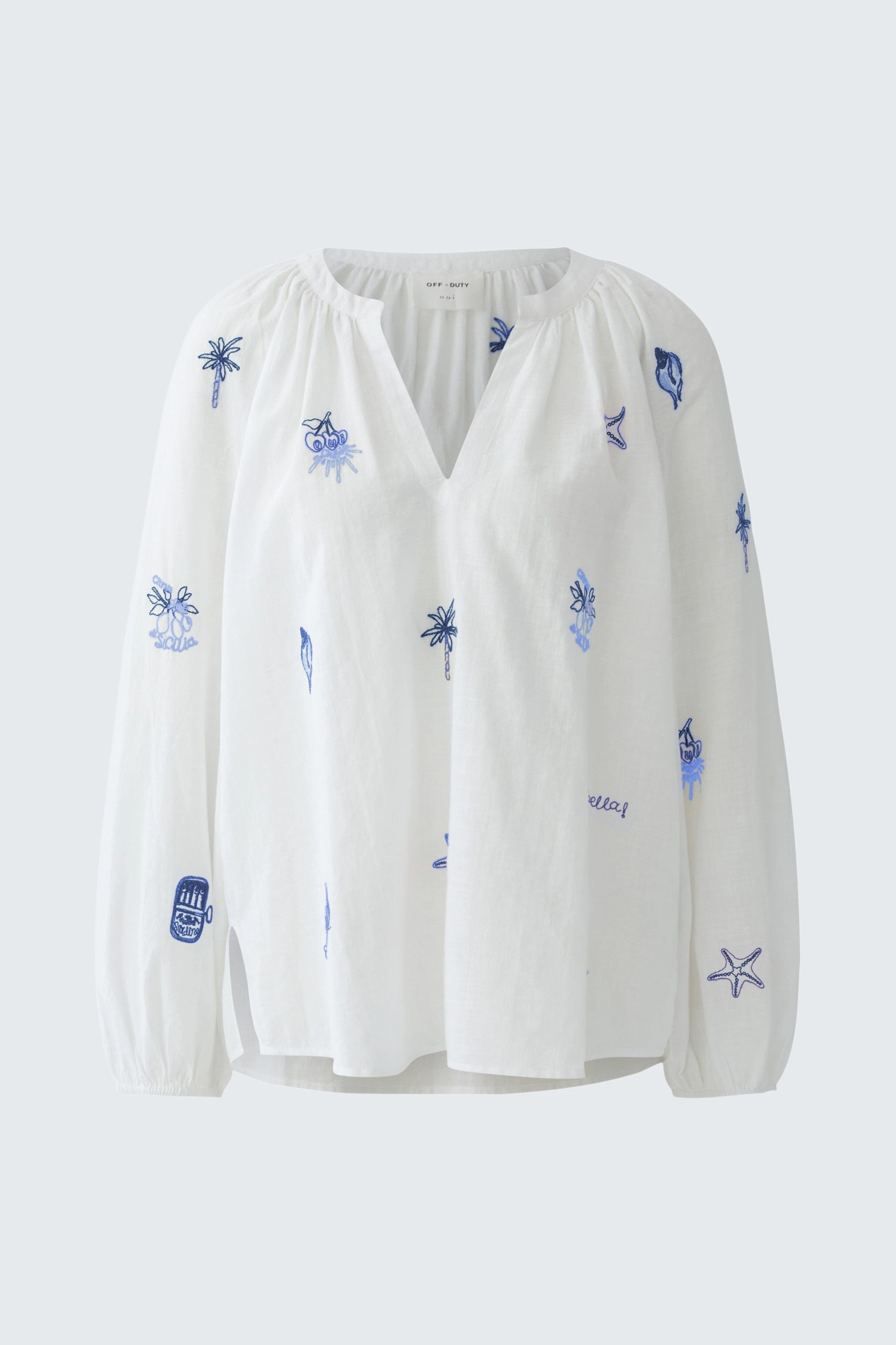 White tunic with blue embroidery, featuring long sleeves and a relaxed fit. No model present.