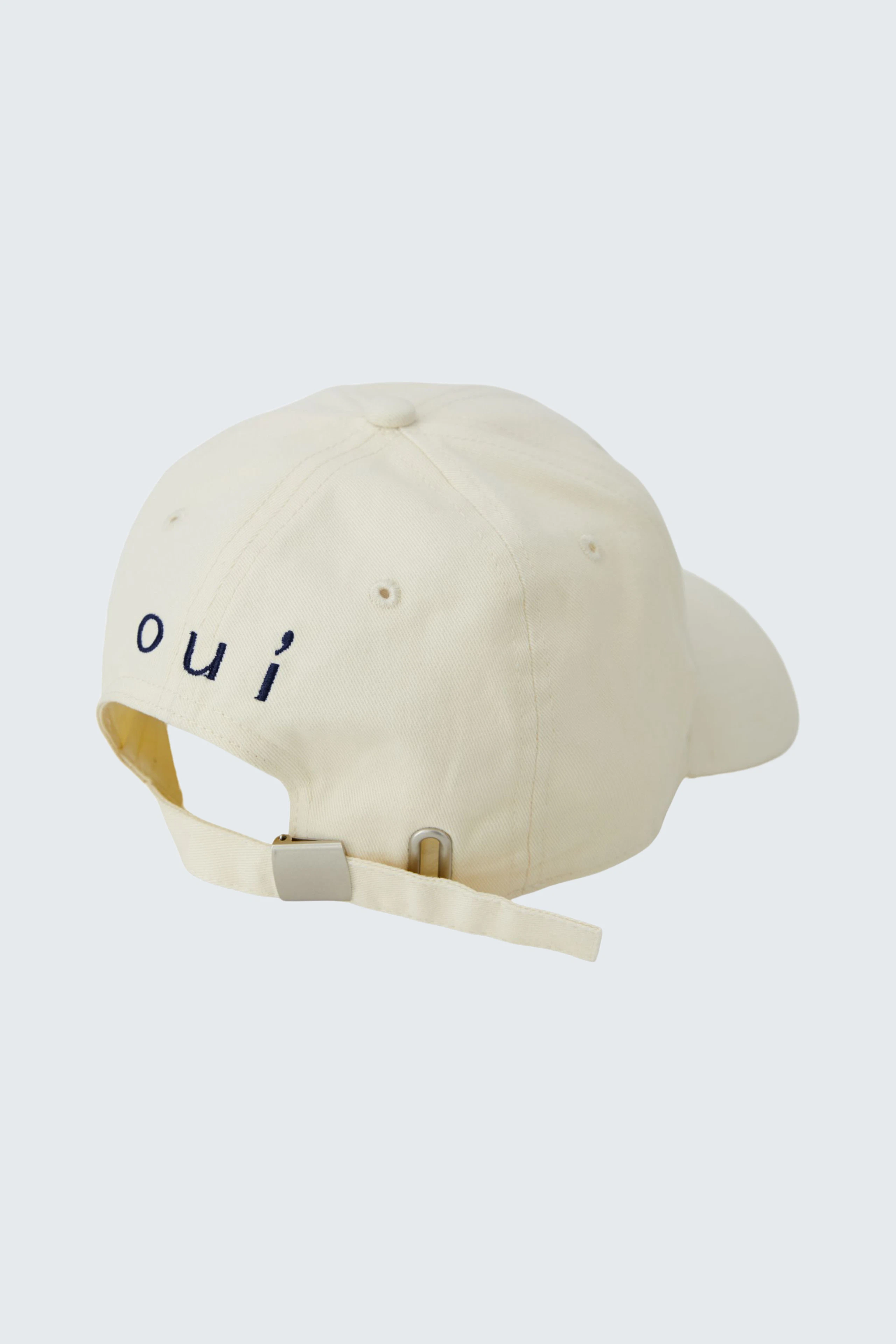 Casual cap: Cream-colored cap with adjustable strap and 'oui' logo on the back.