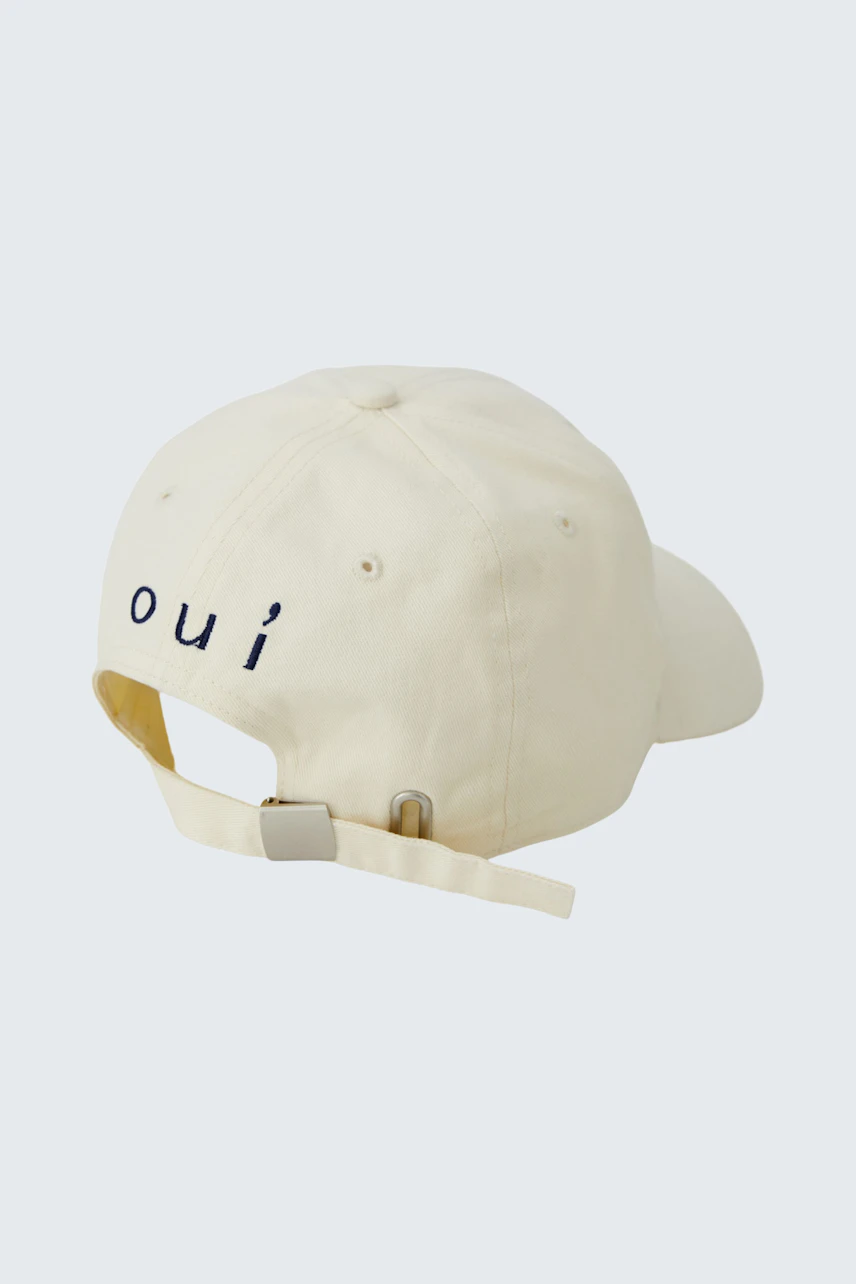 Casual cap: Cream-colored cap with adjustable strap and 'oui' logo on the back.