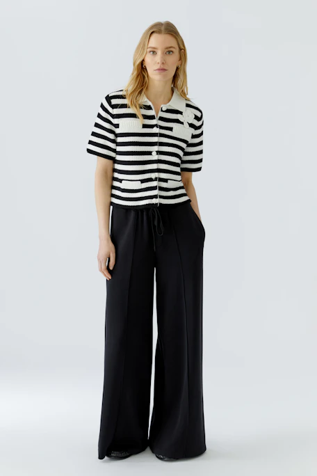 Striped knit cardigan with short sleeves and button front, featuring a white collar and pocket details.