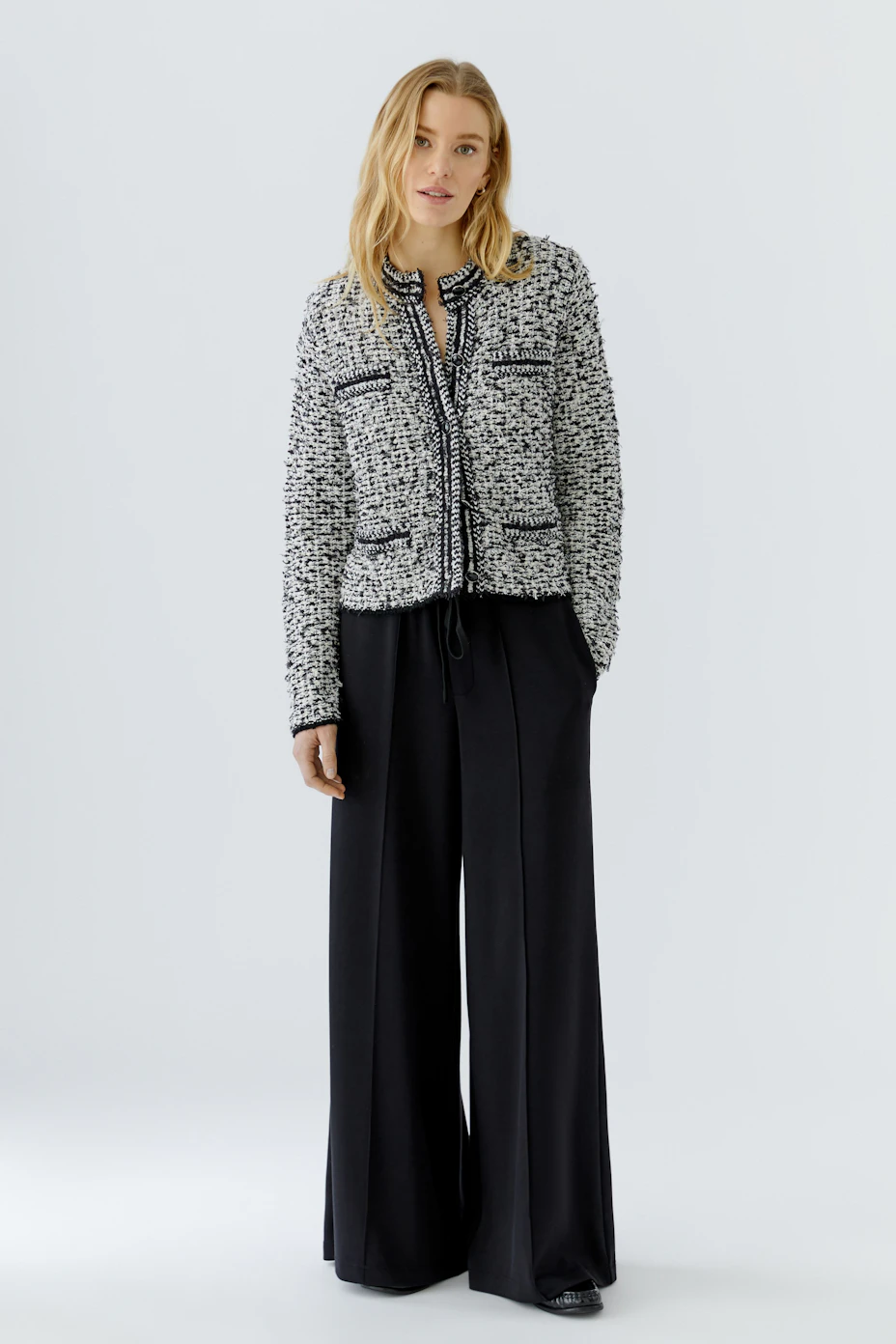 Textured knit cardigan: Black and white pattern with long sleeves, no model visible.