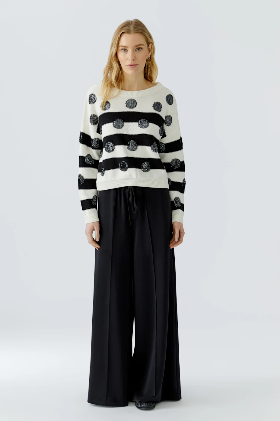 Casual pullover: White with black stripes and polka dots, perfect for a relaxed, stylish look.