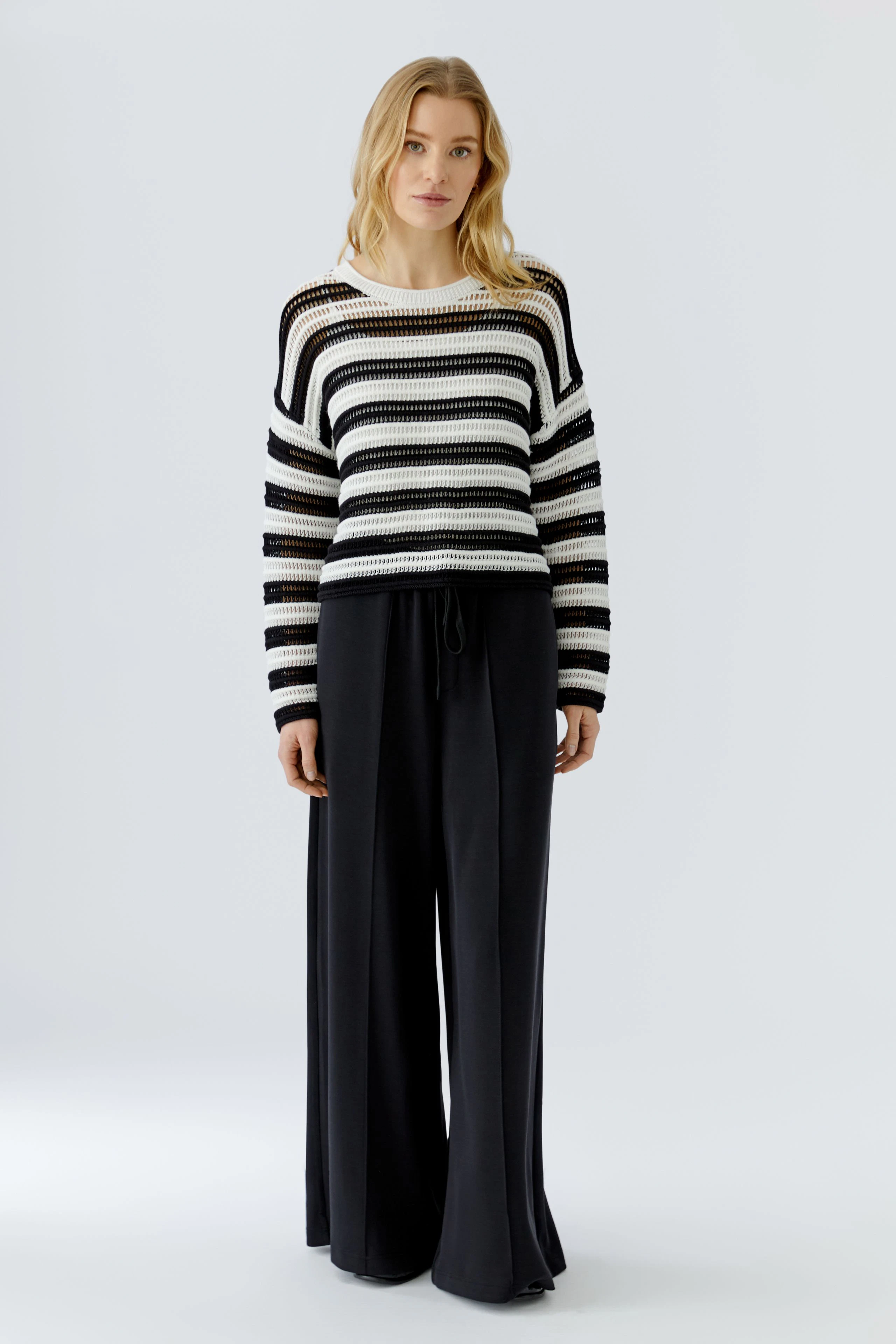 Casual pullover: Black and white striped knit pullover with a relaxed fit, perfect for everyday wear.