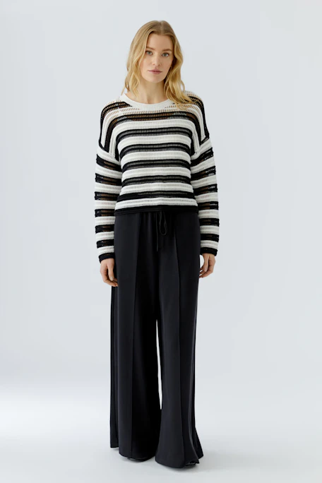 Casual pullover: Black and white striped knit pullover with a relaxed fit, perfect for everyday wear.