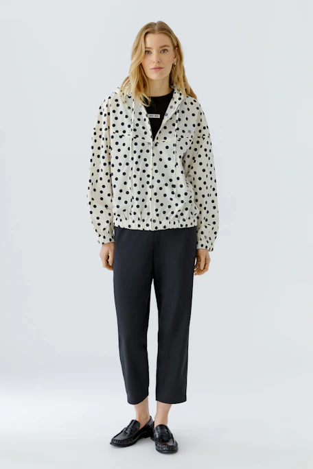Casual women's blouson: White with black polka dots, featuring a hood and elastic cuffs.