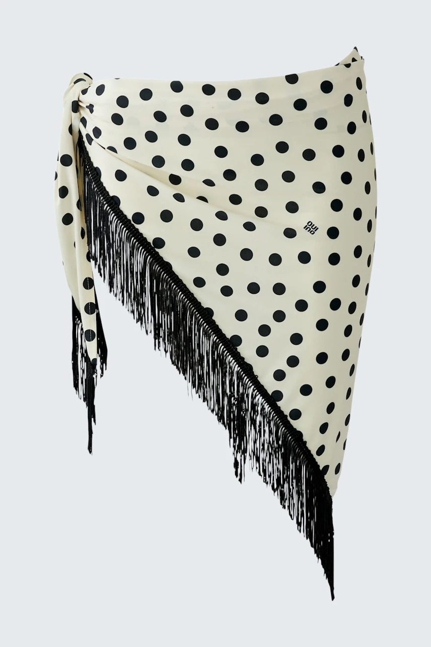 Polka dot scarf with fringe detail, perfect for adding a playful touch to any outfit.