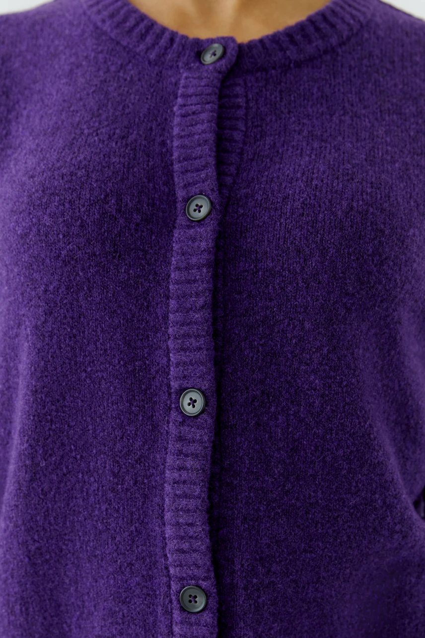 Purple cardigan with buttons, close-up view. Cozy knit texture, perfect for layering.