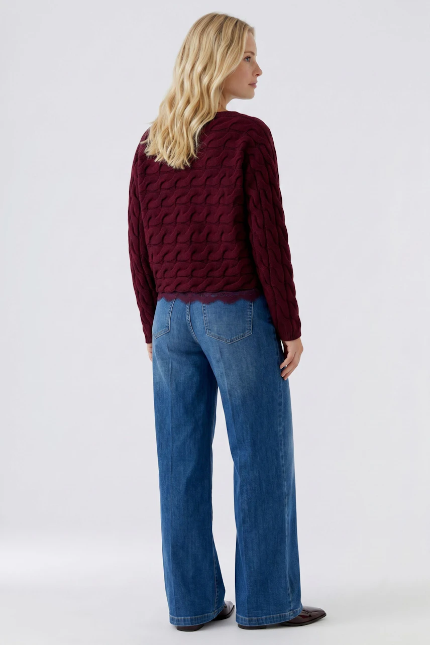 Casual women's pullover: A woman in a burgundy textured pullover and matching pants, viewed from the back.