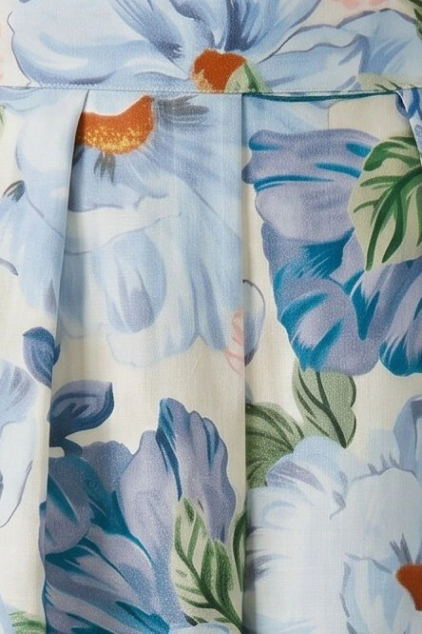 Floral pleated skirt in soft pastels, showcasing vibrant blooms and delicate folds.