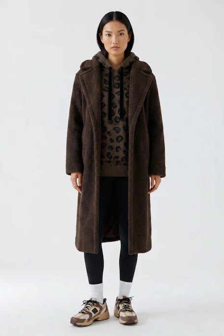 Cozy winter coat: Long brown coat with soft texture, perfect for cold weather. No model shown.