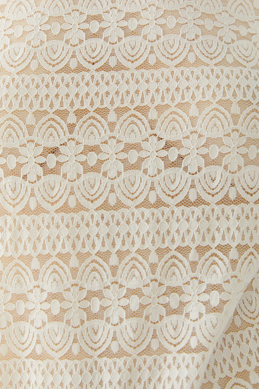 Lace long-sleeve shirt: Delicate white lace pattern on beige fabric, perfect for layering.