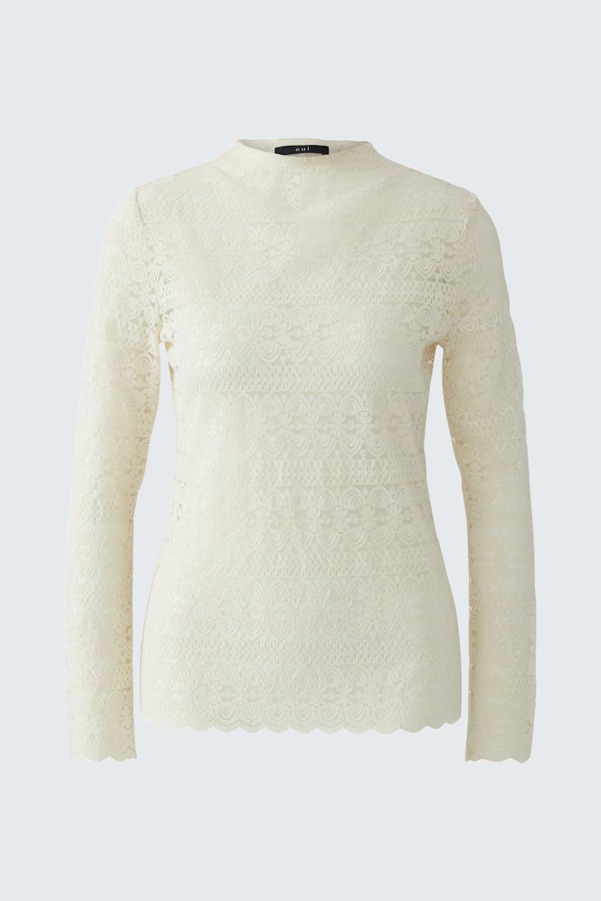 Long-sleeve shirt: A woman in a cream lace pullover with a high neck and long sleeves.