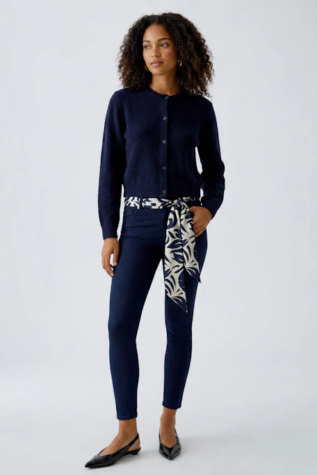 Stylish scarf: A patterned scarf in navy and cream, perfect for adding flair to any outfit.