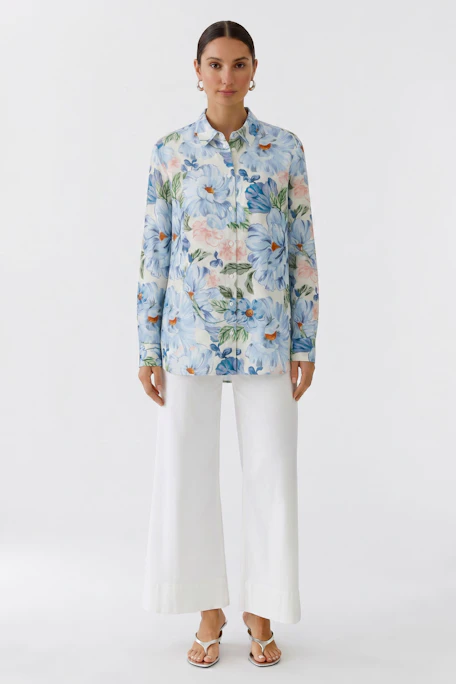Floral print blouse: Vibrant blue and pink flowers on a white background, perfect for a fresh, casual look.